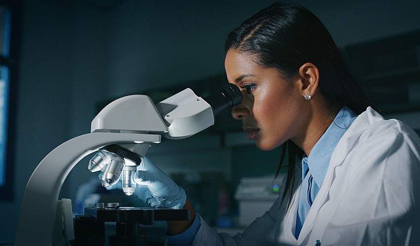 Water lab scientist analyzing sample with AI.