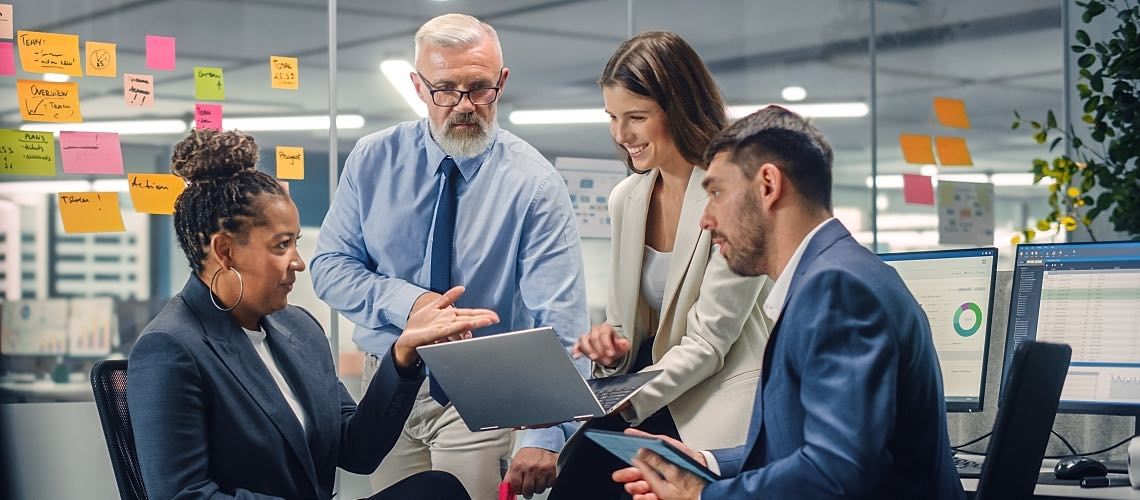 A group of managers sit in an office for a meeting