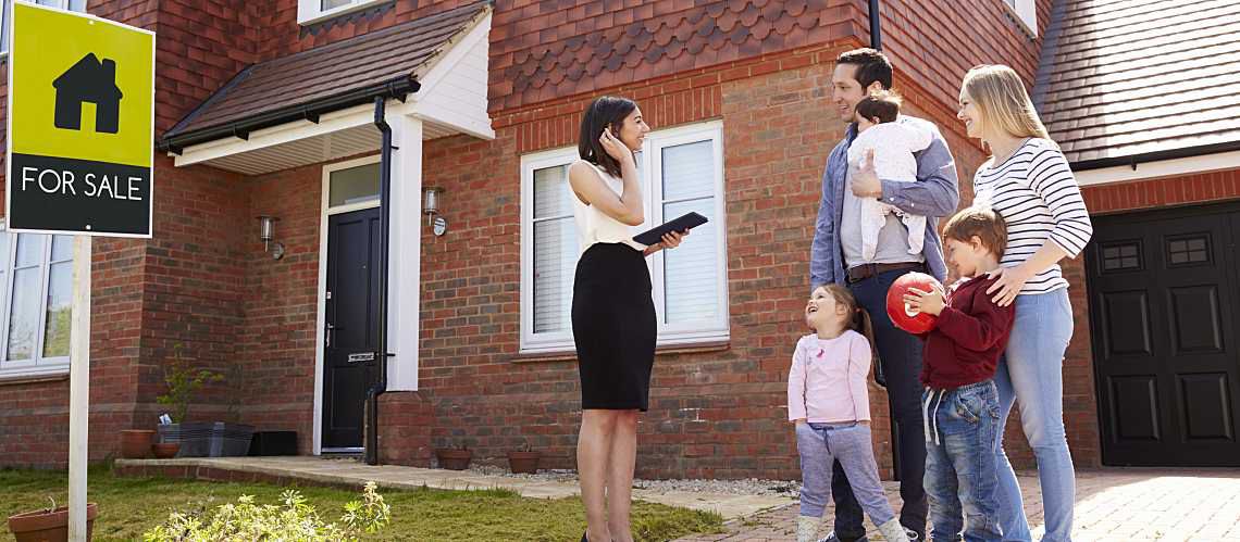 Realtor shows family a home for sale.