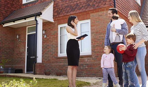 Realtor shows family a home for sale.