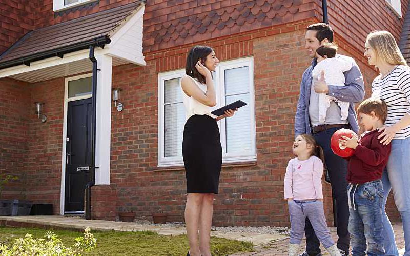 Realtor shows family a home for sale.