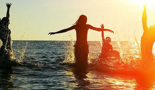 People swimming in the ocean.