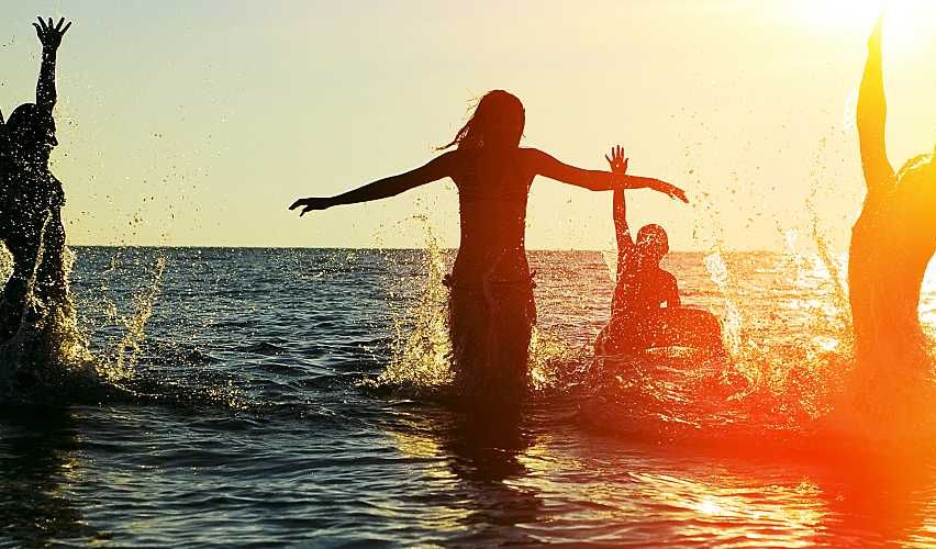 People swimming in the ocean.